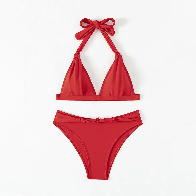 Women's red lace-up halterneck bikini set with split design and matching shorts for swimming