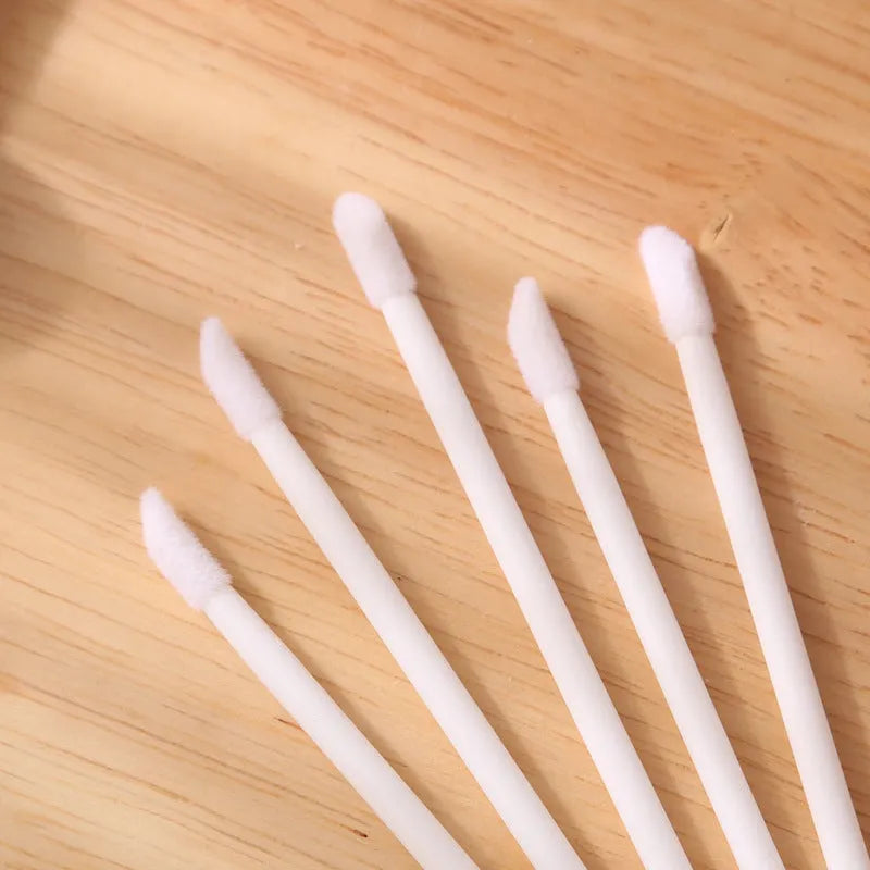 Disposable lip brushes with flocked heads and black handles in various colours