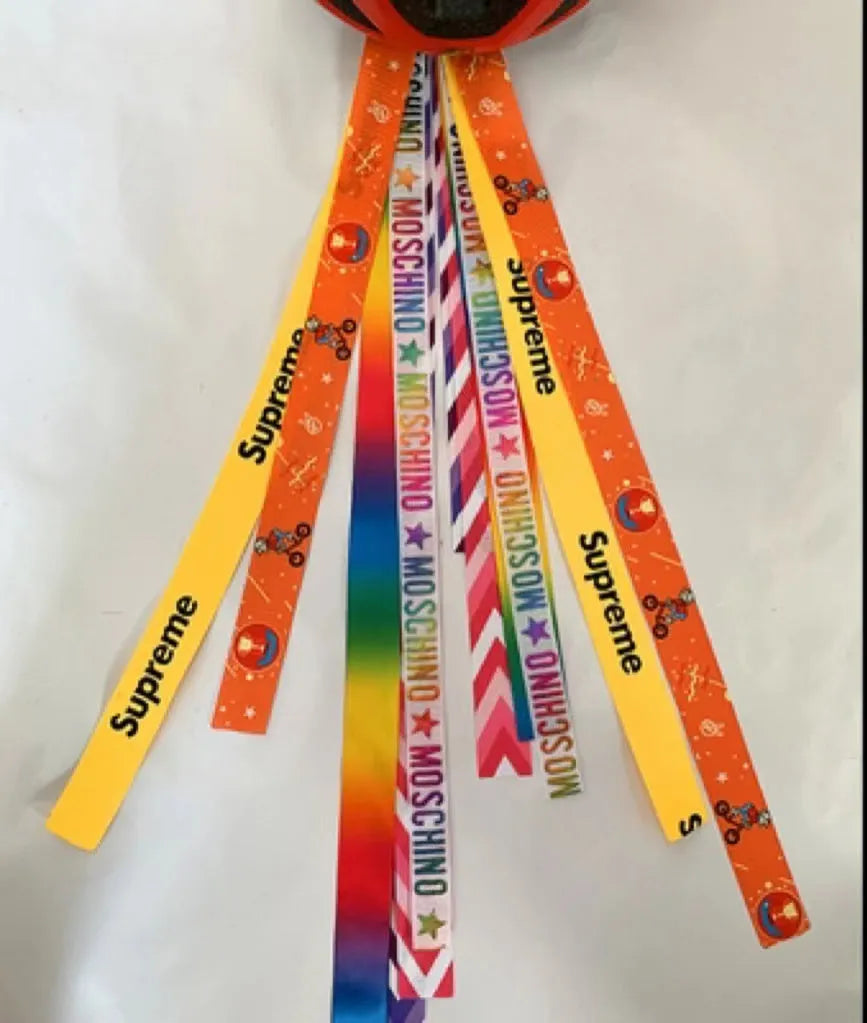 Children's decorative helmet streamer ribbon in multiple colours for roller skating and skiing safety gear.