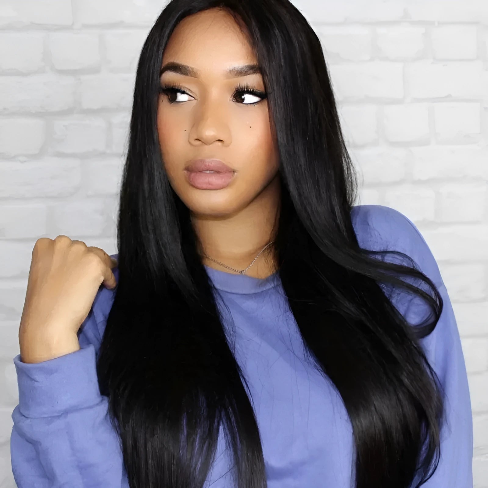 Long straight black synthetic wig with centre-parted bangs on a mannequin head