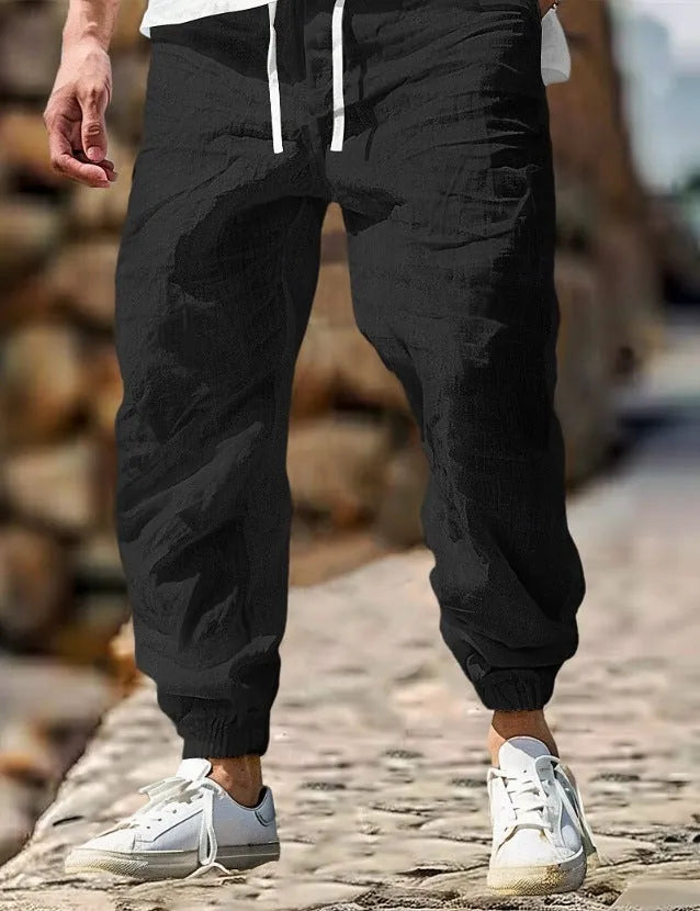 Men's straight-leg linen trousers in apricot colour with an elasticated waistband.