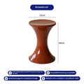 A plastic hourglass-shaped stool for changing shoes, shown in one of five available colours.