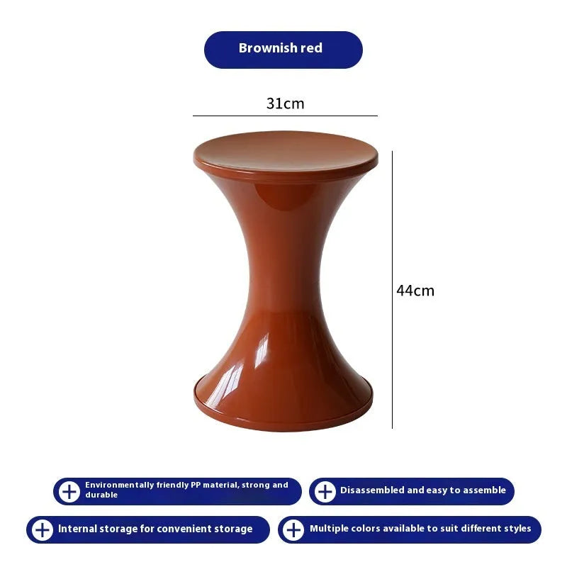 A plastic hourglass-shaped stool for changing shoes, shown in one of five available colours.