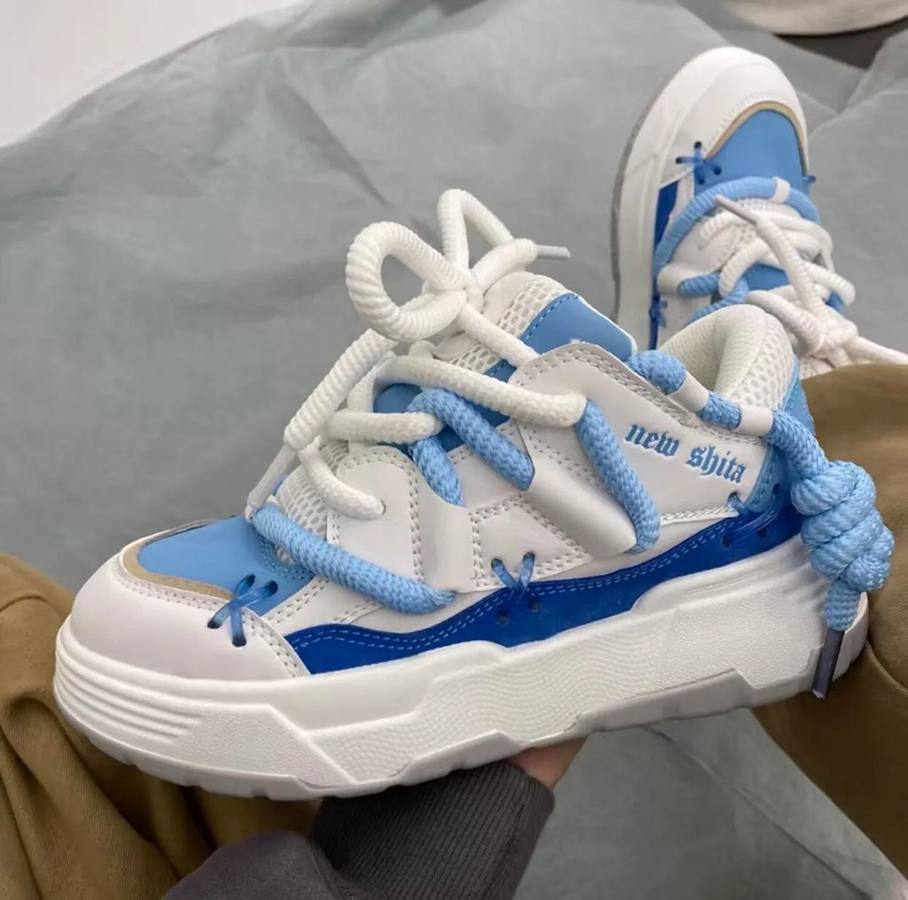 Women's thick bottom grey retro clunky sneakers with high heel on a white background.