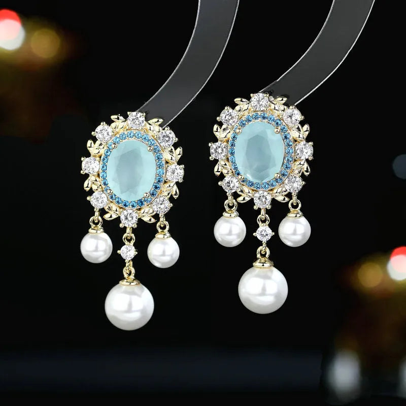 Oval-shaped copper earrings with zircon-inlaid pearls and long decorative tassels in light purple.