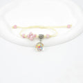 Close-up of a hand-woven glass bracelet with large 1.4 cm beads containing real dried flowers in multiple colour options.