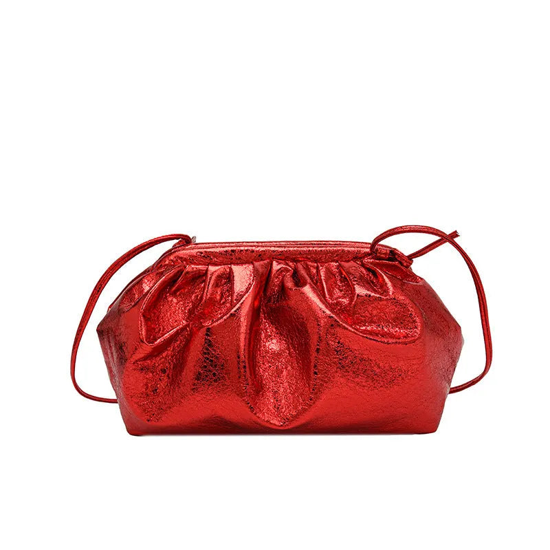 Shell-shaped crossbody bag with hair clip shoulder strap showing multiple compartments including mobile phone pocket