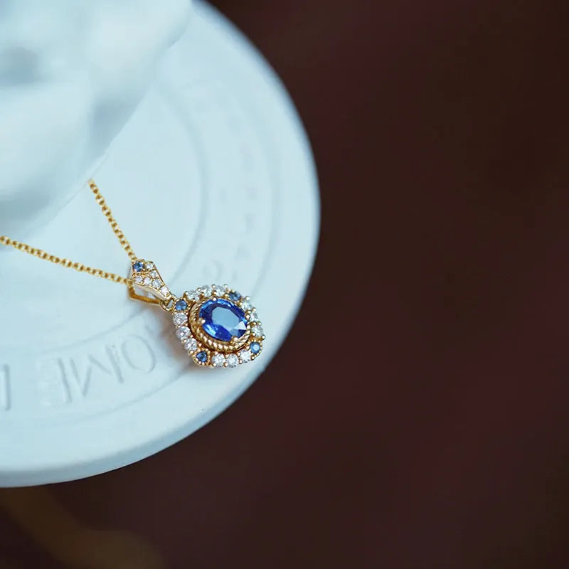 Golden women's necklace with mixed gem inlaid pendant on an adjustable copper box chain.