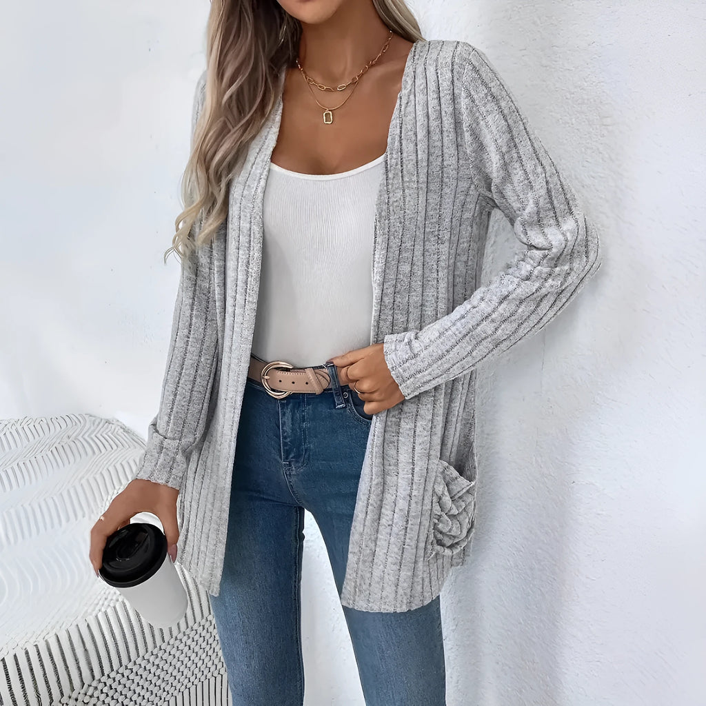 Grandma Grey loose fit long sleeve cardigan with two front pockets, shown on a hanger.