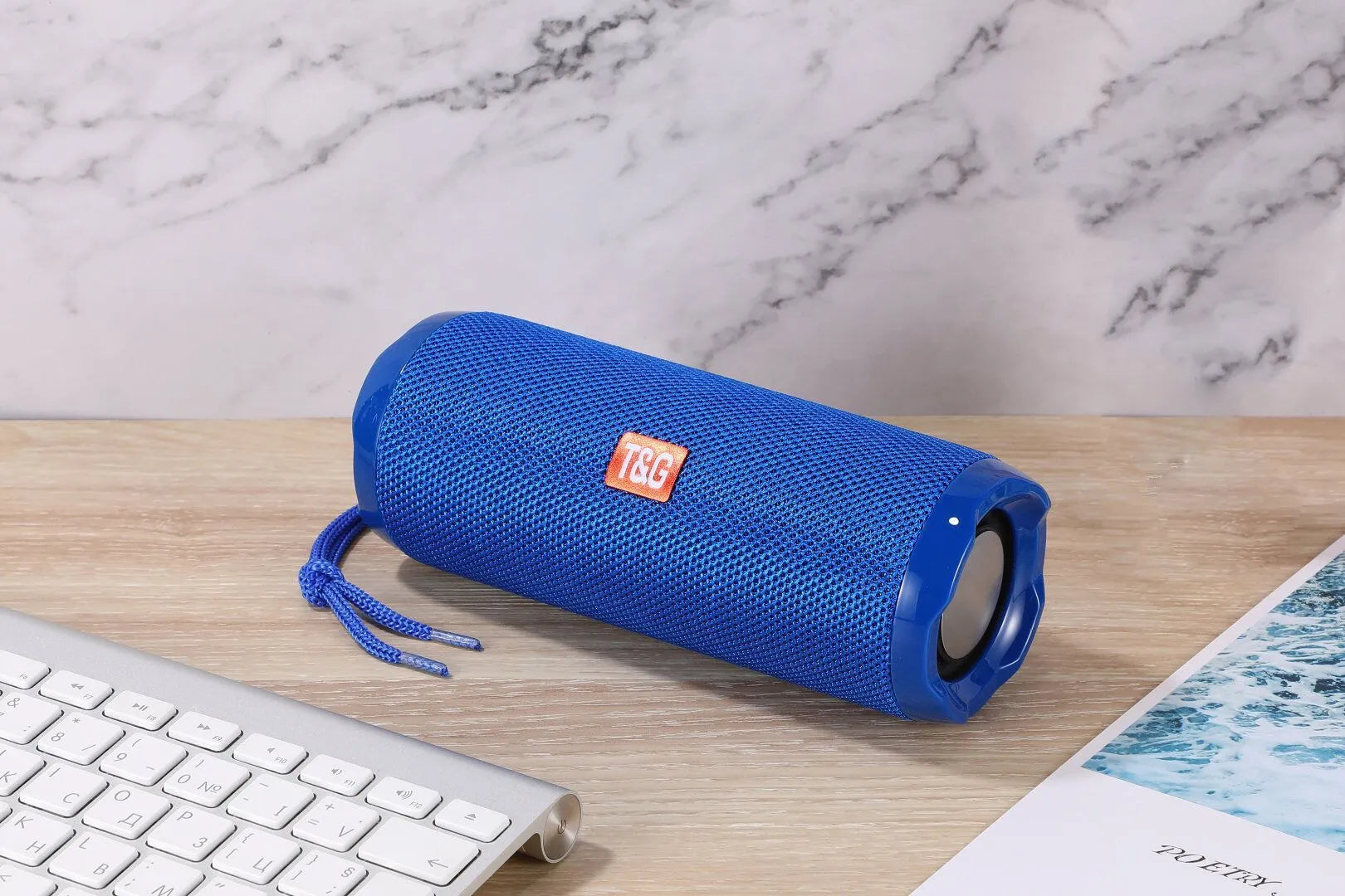 Fabric-covered portable Bluetooth speaker with integrated card holder slot in blue colour