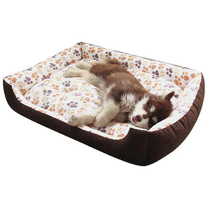 Beige plush sofa-style pet bed for small dogs with a raised bolster edge, shown in a home setting.