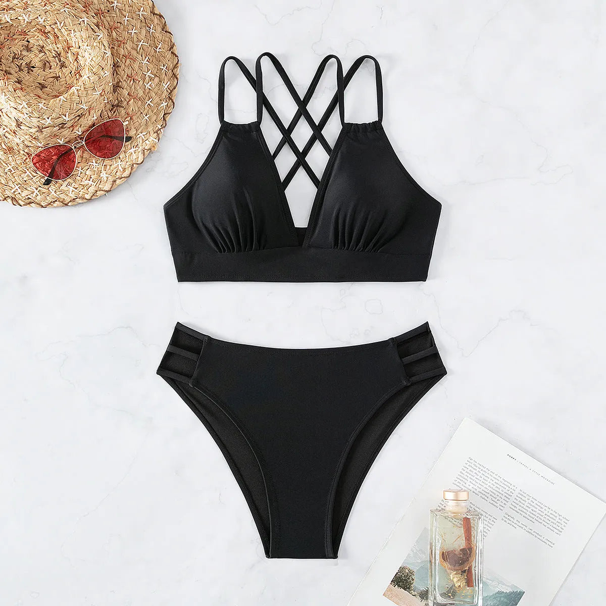 Women's black V-neck halter bikini with split leg shorts on a mannequin.