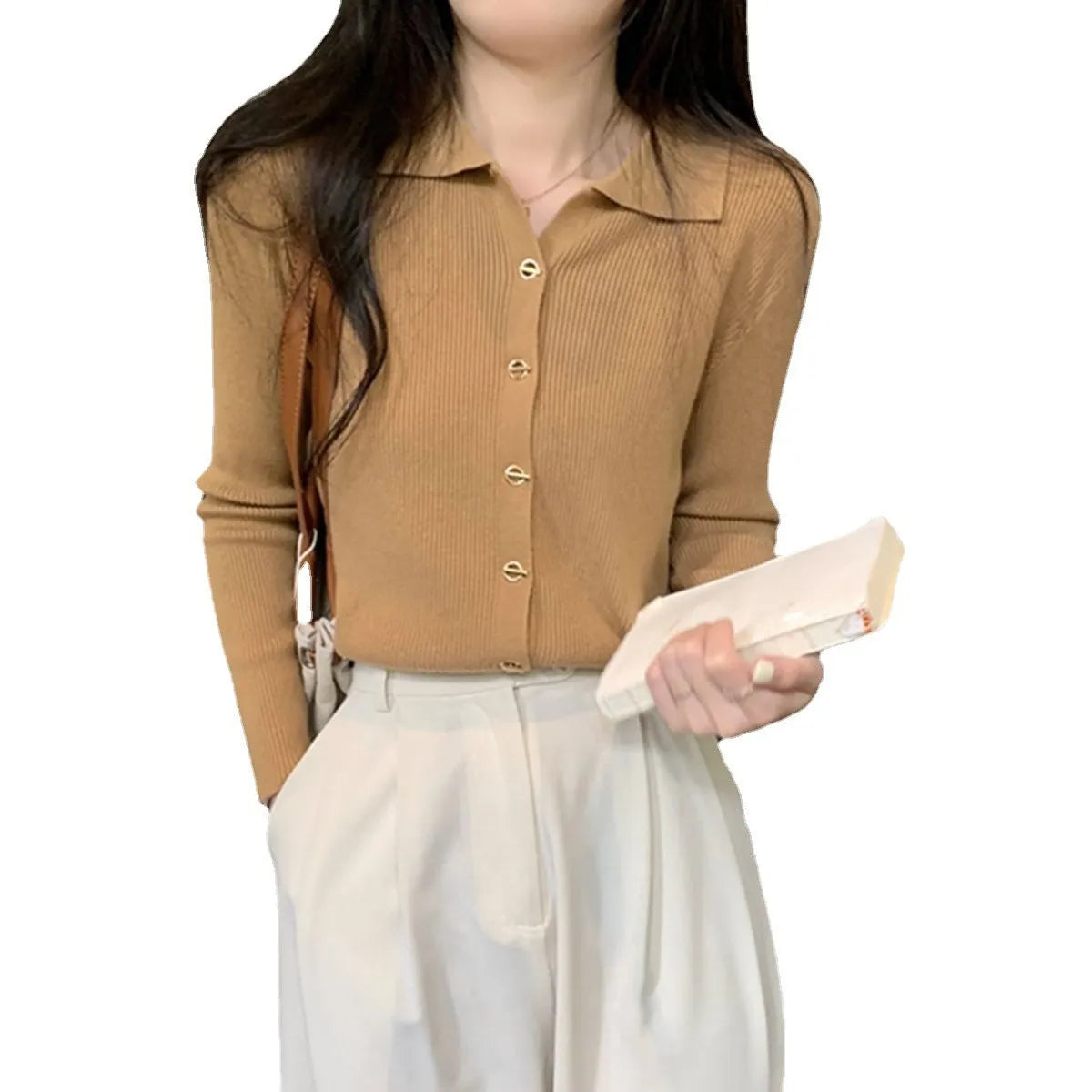 Beige loose fit long-sleeved viscose knitted cardigan top worn open as a layer.