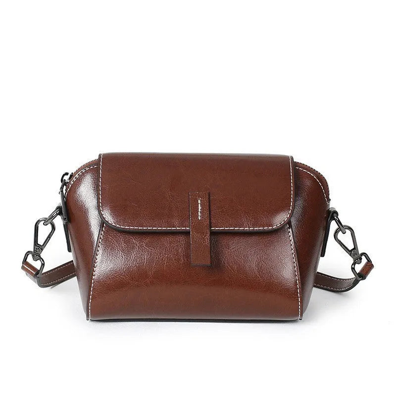 Women's brown oil wax leather messenger bag with crossbody strap and multiple internal pockets