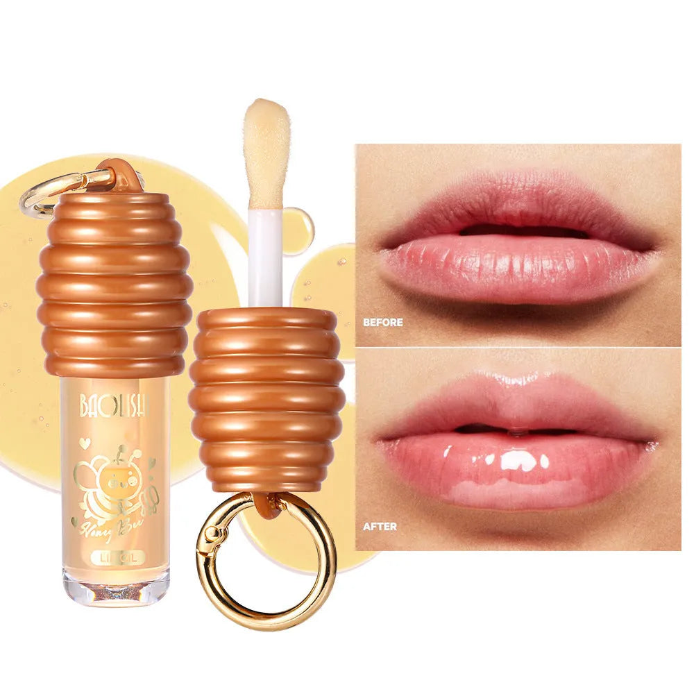 Portable honey lip gloss canister with keychain attachment for moisturising and nourishing lips.