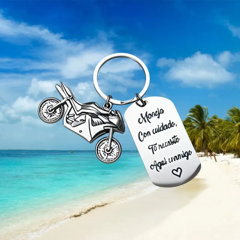 Stainless steel motorcycle keychain with inspirational design on a flannel bag.