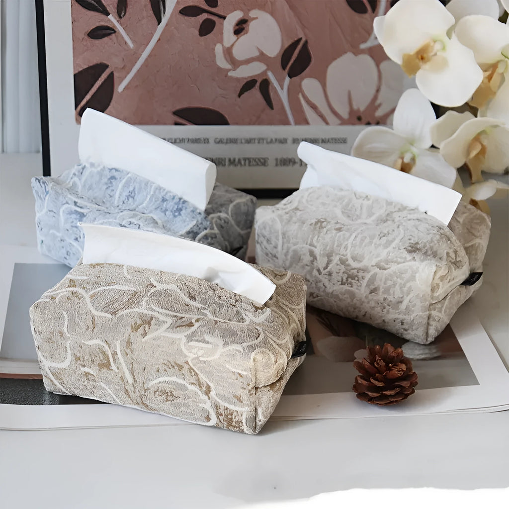 Handmade beige rose patterned cotton fabric tissue box cover on a wooden table.