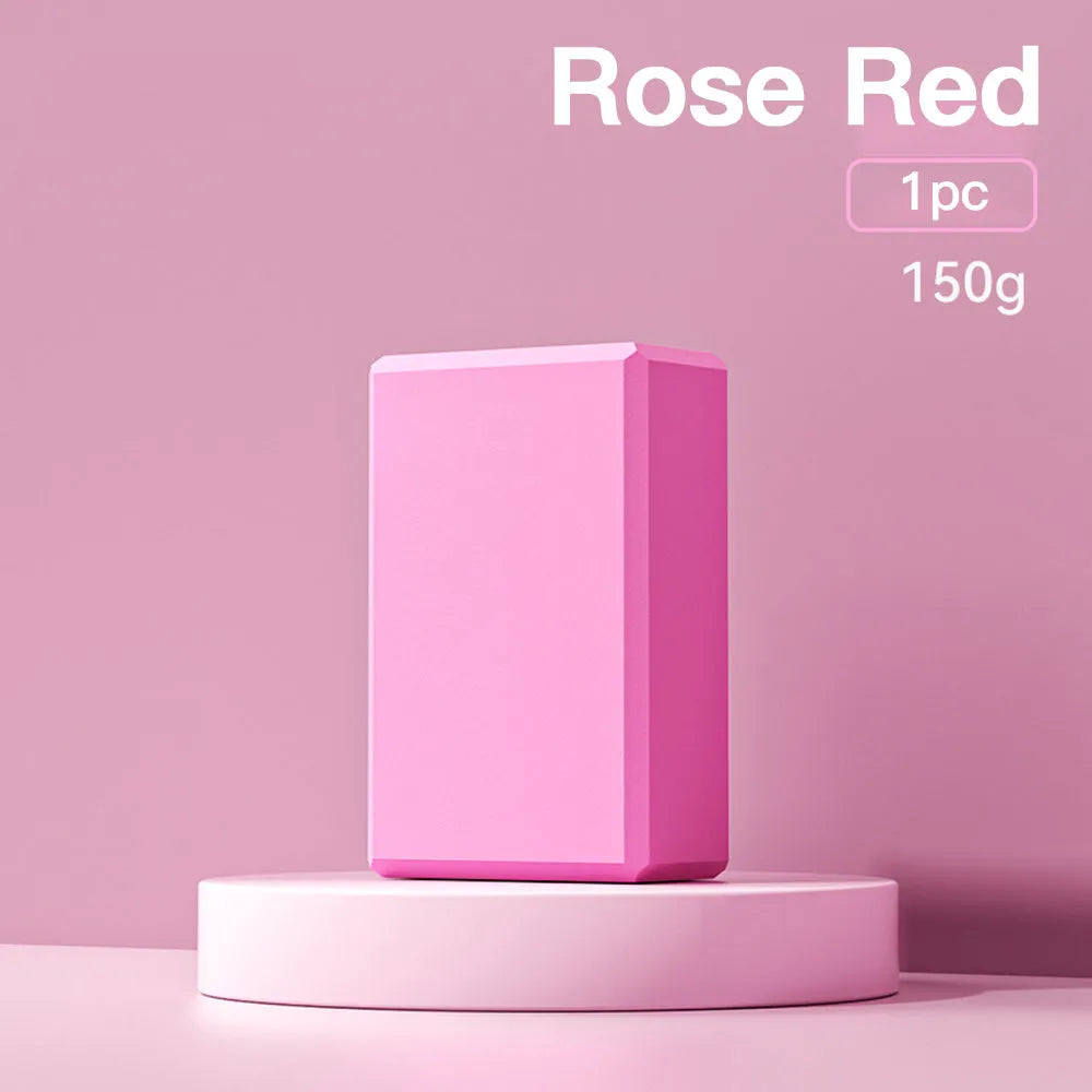 Solid colour high-density EVA foam yoga block with ridged sides on a gym mat