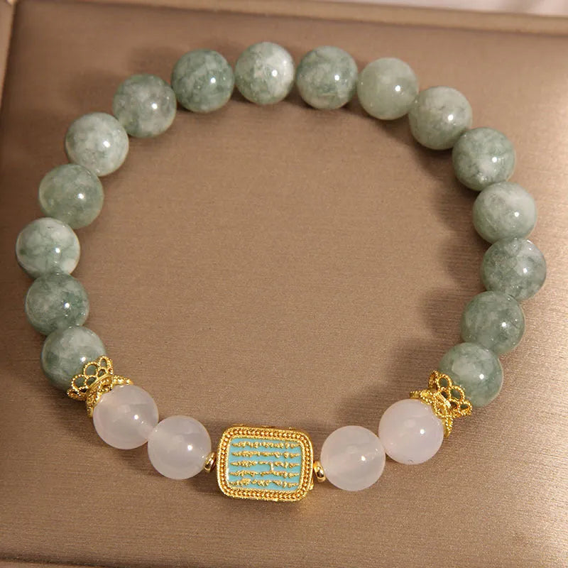 Oil green emerald crystal bracelet for women with five scripture charms on a white background.