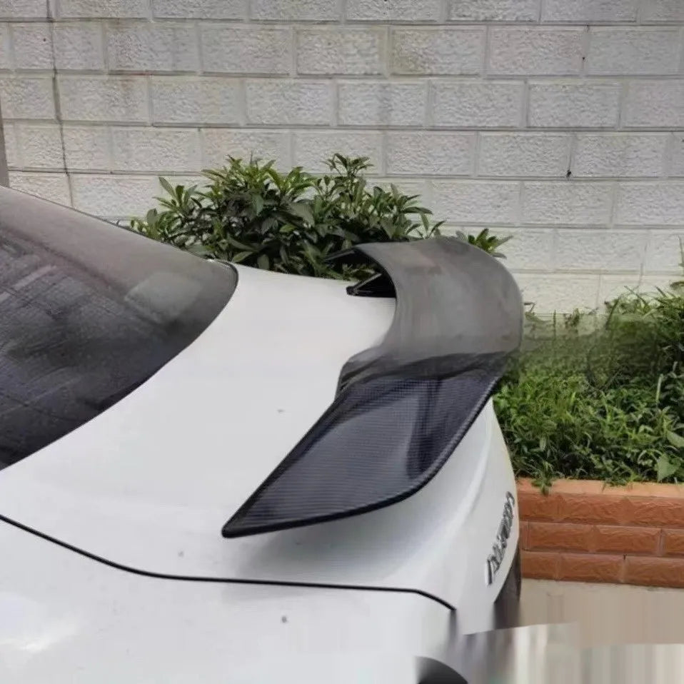 Punch-free adhesive mount car spoiler in ABS plastic, shown in carbon pattern finish.