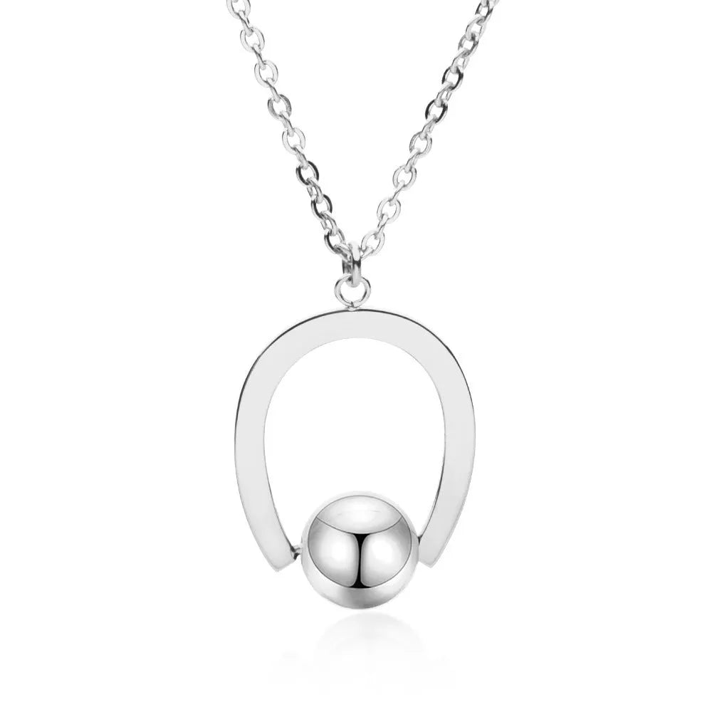 Stainless steel necklace with geometric pendant on a cross chain, in gold or silver colour.
