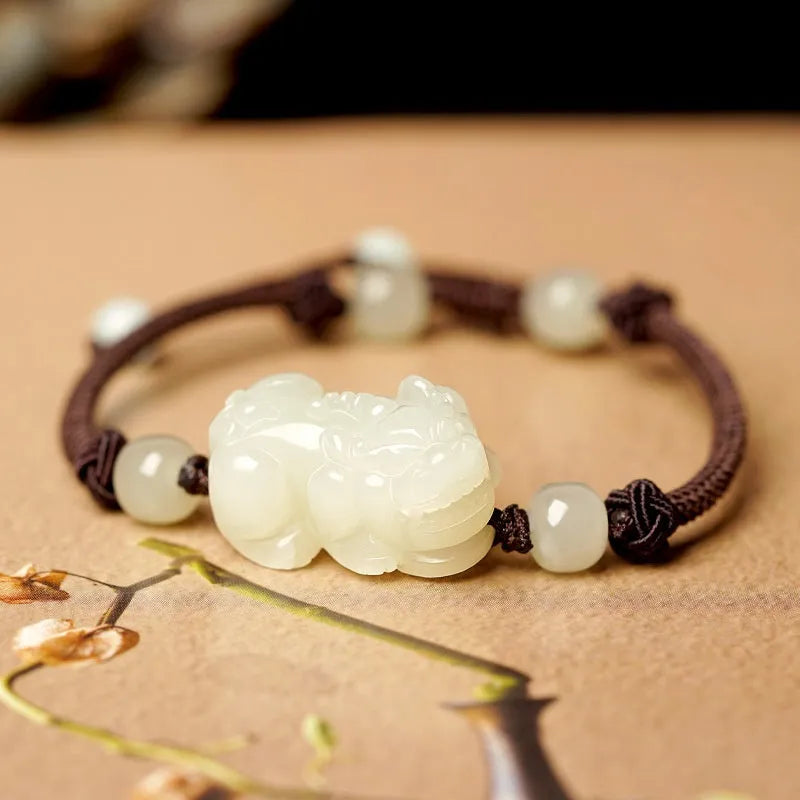Hetian Jade bracelet with a black and red braided rope band and a central jade bead.