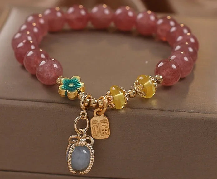 Red strawberry quartz and rhinestone beaded bracelet with an alloy clasp.