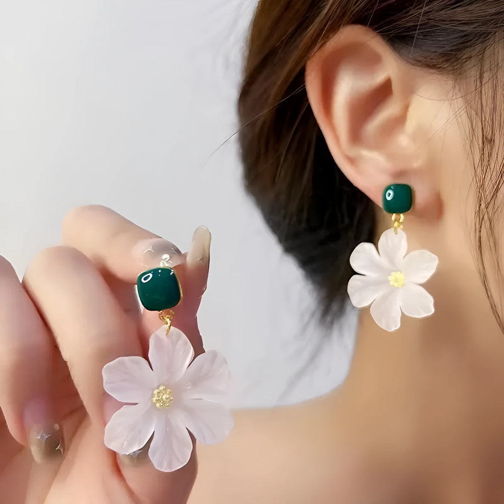 A pair of dark green alloy earrings with a detailed needle flowers sweet floral design.