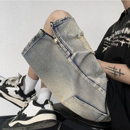 Blue distressed denim shorts with wide-leg loose fit and retro tattered styling on hanger