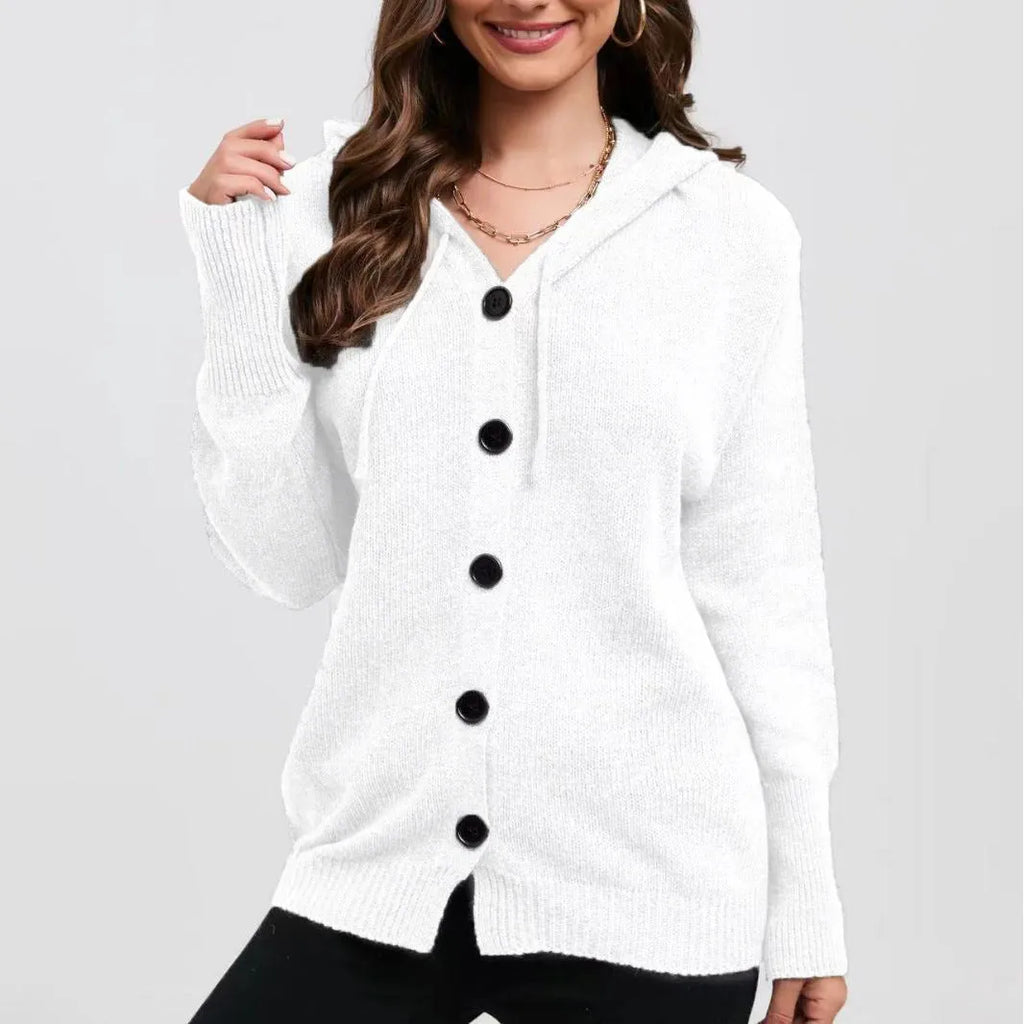 Woman wearing a thick, loose-fit grey hooded cardigan sweater with long sleeves.