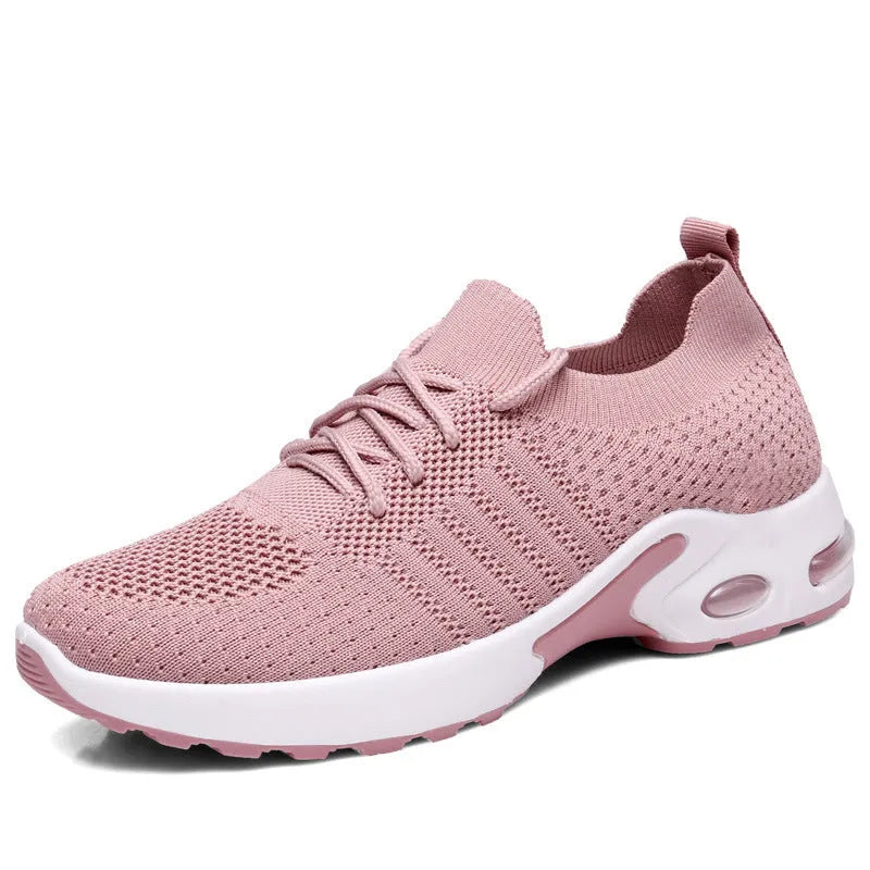 Women's black mesh casual sneakers with round toe and white non-slip sole on a grey background.