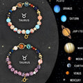 Set of twelve beaded bracelets with natural stone beads and sterling silver zodiac charms on a dark background.