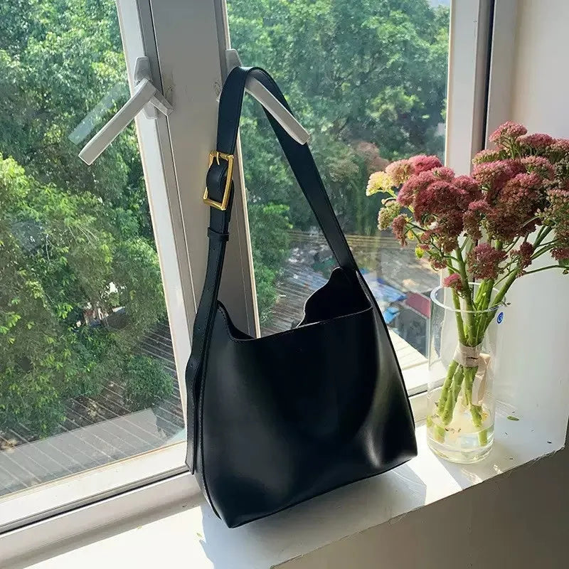 Women's soft PU shoulder bag with swing thread detailing in black ribbon or brown colour options