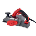 Red desktop electric wood planer with aluminium housing showing 82mm cutting width