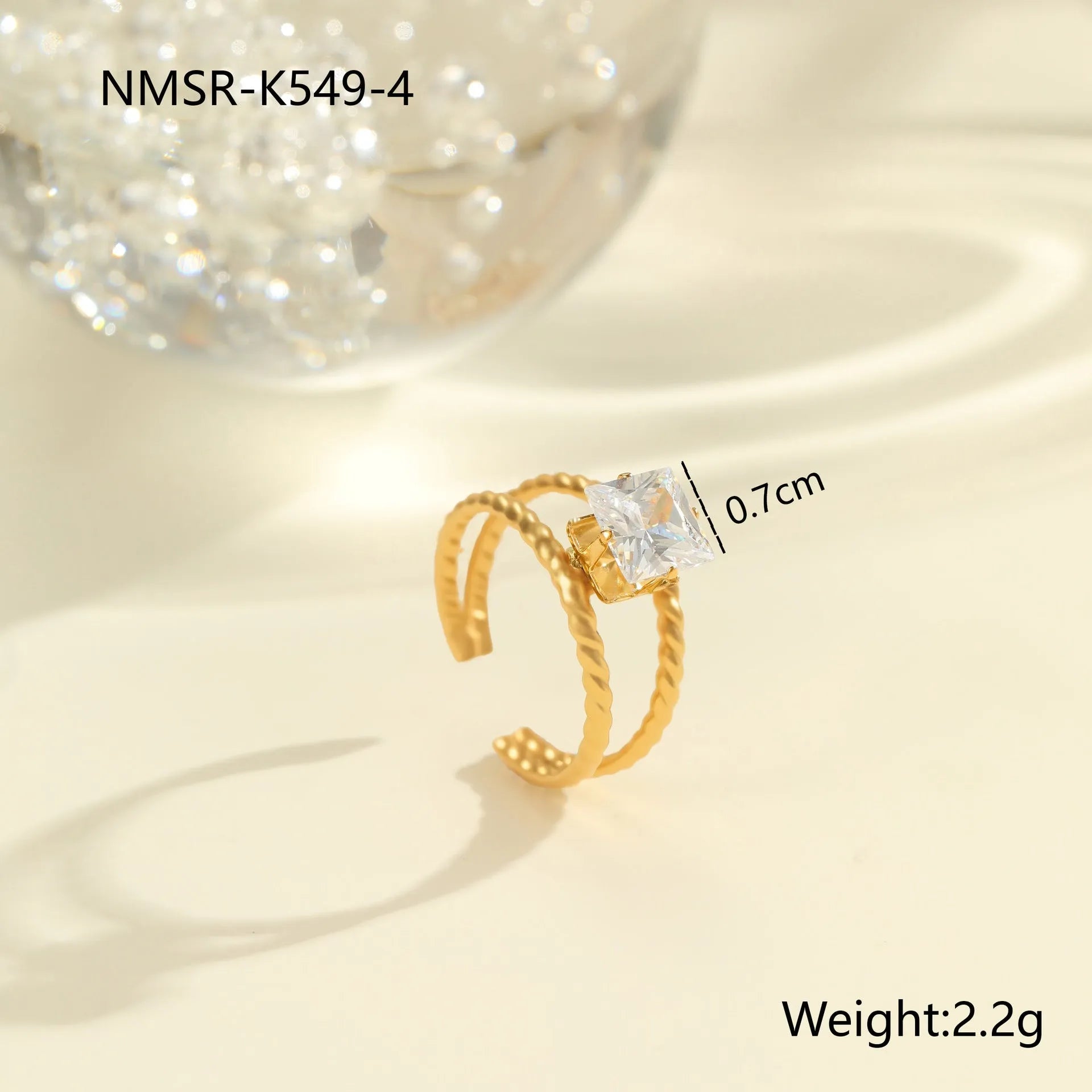 Gold-coloured stainless steel open ring with zircon stones in a geometric heart design.