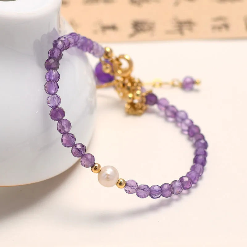 Women's amethyst Chinese style crystal bracelet with diamond-shaped beads and electroplated metal.