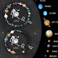 Set of two natural stone beaded bracelets featuring zodiac sign charms on a neutral background.