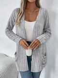 Grandma Grey loose fit long sleeve cardigan with two front pockets, shown on a hanger.
