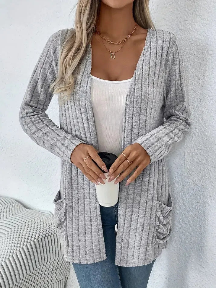 Grandma Grey loose fit long sleeve cardigan with two front pockets, shown on a hanger.