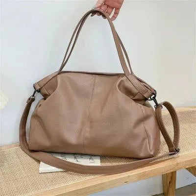 Large soft surface black messenger bag with a shoulder strap and zipper opening.