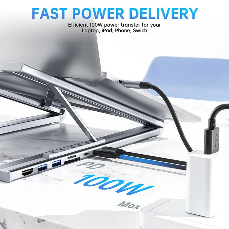 Silver aluminium alloy folding laptop stand with a built-in multi-port docking station hub.