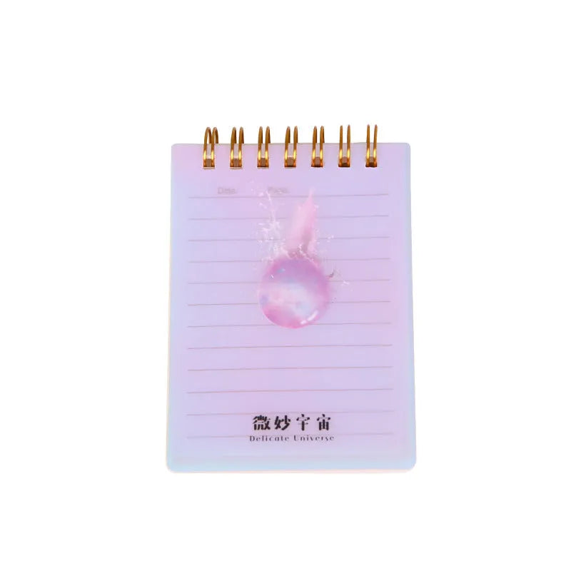 Set of four A7 spiral notebooks with different coloured covers showing constellation, cherry blossom, ocean, and universe designs.