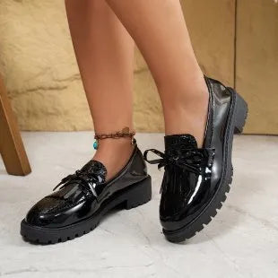 Women's brown and black bow-detailed flat loafers made from artificial PU, shown from the side.