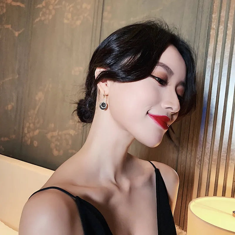 Black geometric alloy drop earrings with round piece design measuring 3.6cm in length
