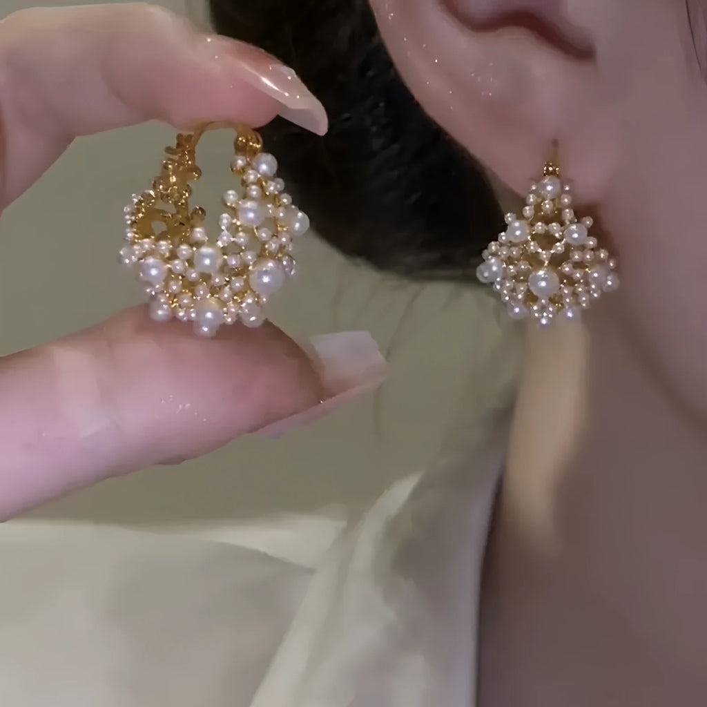 Gold copper flower basket earrings with small rice-shaped bead decoration and pearl inlay.