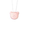 Small pink USB portable air purifier necklace on a table with charging cable.
