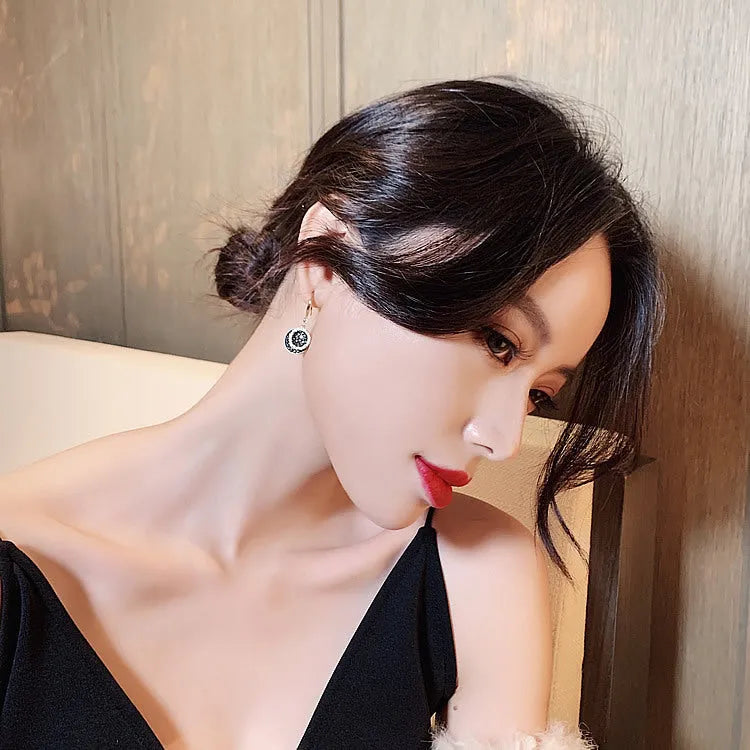 Black geometric alloy drop earrings with round piece design measuring 3.6cm in length