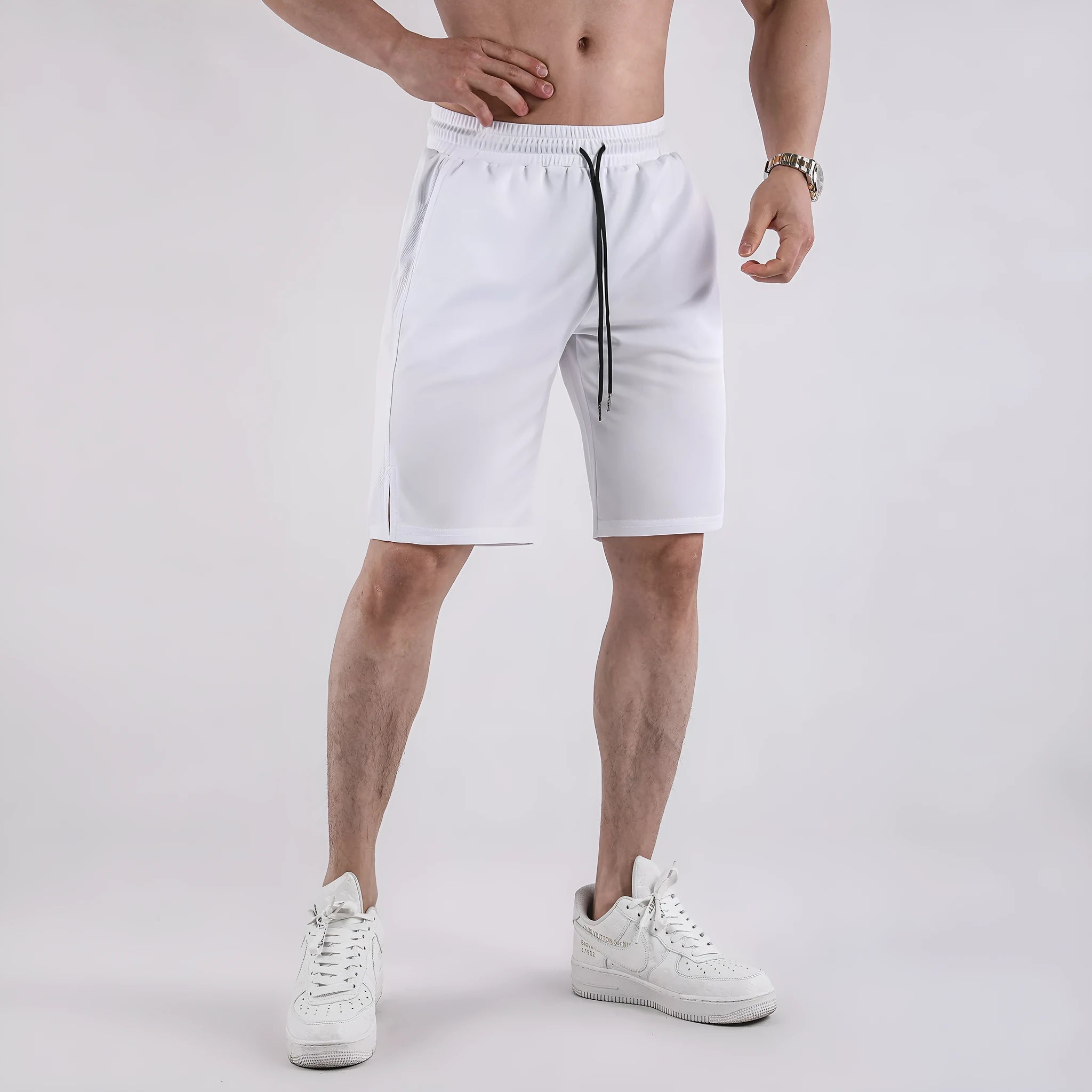 Man wearing black quick-dry mesh fitness shorts with a loose, casual fit and elasticated waistband.