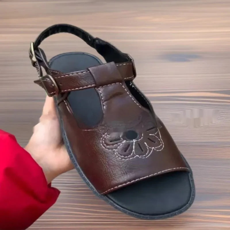 Men's black embroidered beach sandals with flower pattern showing flat heel and PU upper material