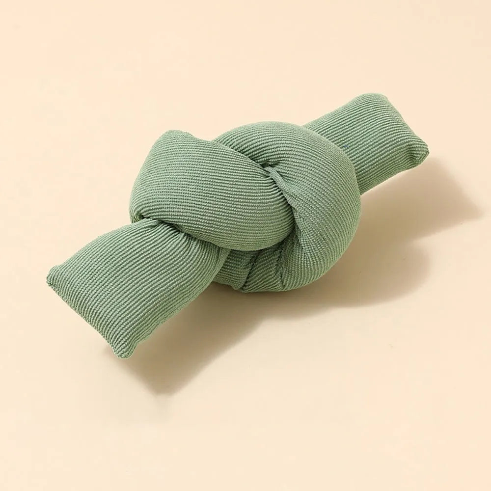 White cotton knotted dog rope toy for tugging and chewing games.